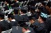 Graduates in hats and gowns at a ceremony